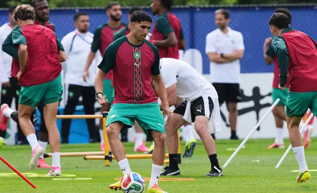 Morocco's Achraf Hakimi exercises during a training session ahead of the World Cup Group C soccer match between Scotland and Morocco in Foxborough, Mass., near Boston, Thursday, June 18, 2026. (AP Photo/Martin Meissner)