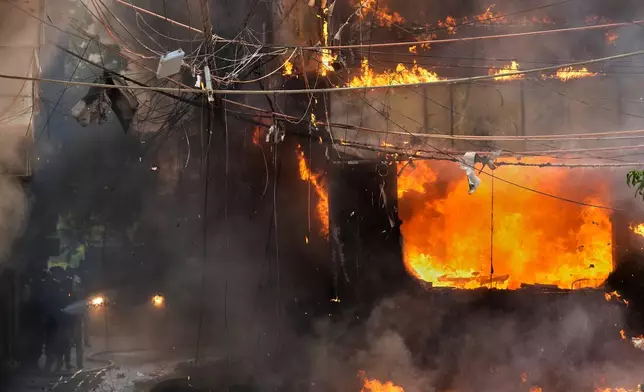 Fire officials douse a fire at a hotel in New Delhi, India, Wednesday, June 3, 2026. (AP Photo/Manish Swarup)