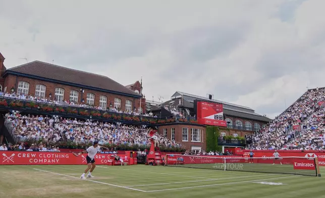 Francisco Cerundolo of Argentina, left plays a return to Tommy Paul of the United States during the men's final at the Queen's Club tennis championships in London, Sunday, June 21, 2026. (AP Photo/Maja Smiejkowska)