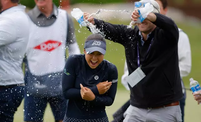 Yana Wilson, center, is doused on the 18th hole after winning the Dow Championship LPGA golf tournament, Sunday, June 14, 2026, at Midland Country Club in Midland, Mich. (AP Photo/Al Goldis)