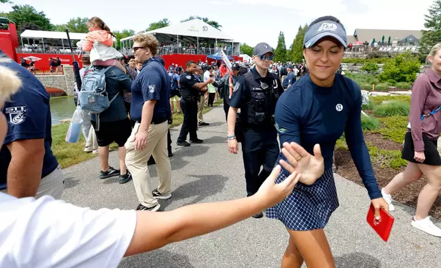 Yana Wilson greets fans as she walks to the clubhouse after finishing the final round of the Dow Championship LPGA golf tournament, Sunday, June 14, 2026, at Midland Country Club in Midland, Mich. (AP Photo/Al Goldis)