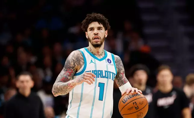 FILE - Charlotte Hornets guard LaMelo Ball brings the ball up the court against the Miami Heat during the first half of an NBA play-in tournament basketball game in Charlotte, N.C., April 14, 2026. (AP Photo/Nell Redmond, file)