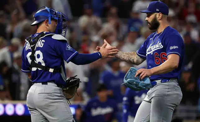 Los Angeles Dodgers catcher Dalton Rushing, left, and pitcher Tanner Scott celebrates their teams win against the Minnesota Twins after a baseball game, Wednesday, June 24, 2026, in Minneapolis. (AP Photo/Matt Krohn)