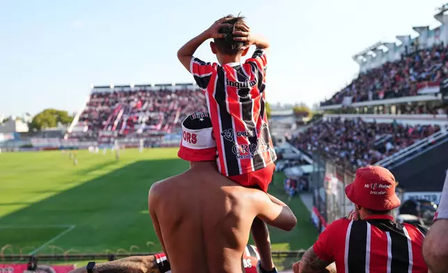 Chacarita Juniors fans react during an Argentine league against Gimnasia y Tiro in Buenos Aires, Argentina, Sunday, April 12, 2026. (AP Photo/Rodrigo Abd)