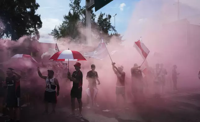 River Plate fans gather on a highway prior to an Argentine league match against Boca Juniors in Buenos Aires, Argentina, Sunday, April 19, 2026. (AP Photo/Rodrigo Abd)