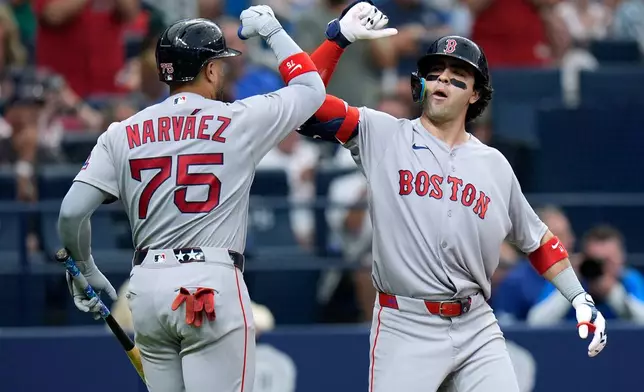 Boston Red Sox's Marcelo Mayer celebrates his solo home run off Tampa Bay Rays pitcher Ian Seymour with Carlos Narváez (75) during the third inning of a baseball game Monday, June 8, 2026, in St. Petersburg, Fla. (AP Photo/Chris O'Meara)