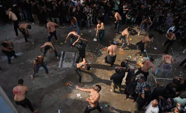 Shiite Muslims flagellate themselves during a Muharram procession in Ahmedabad, India, Tuesday, June 23, 2026. (AP Photo/Ajit Solanki)