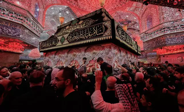 Shiite worshippers visit the holy shrine of Imam Husseinon, during "Muharram," a period of mourning for Shiites in Karbala, Iraq, Wednesday, June 24, 2025. (AP Photo/Hadi Mizban)