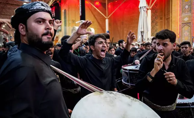 Shiites participate in Muharram processions of the Imam Ali shrine in Najaf, Iraq, Sunday, June 21, 2026, to mark the death of Hussein, the grandson of the Prophet Muhammad in present-day Iraq in the 7th century. (AP Photo/Anmar Khalil)