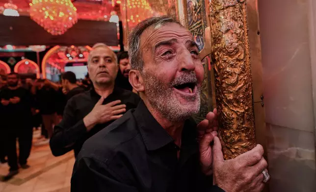 Shiite worshippers visit the holy shrine of Imam Husseinon, during "Muharram," a period of mourning for Shiites in Karbala, Iraq, Wednesday, June 24, 2025. (AP Photo/Hadi Mizban)