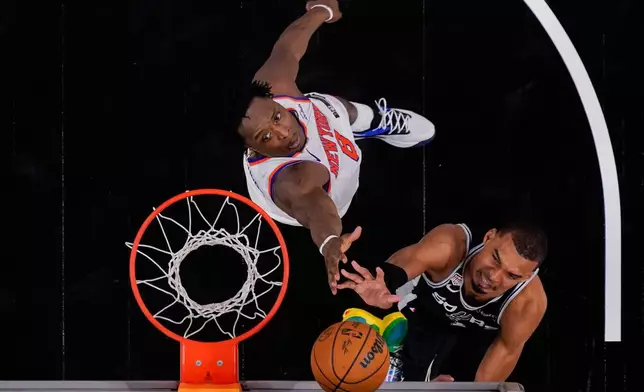 San Antonio Spurs forward Victor Wembanyama shoots over New York Knicks forward Og Anunoby (8) during the second half of Game 1 of the NBA Finals basketball series, Wednesday, June 3, 2026, in San Antonio. (AP Photo/Eric Gay)