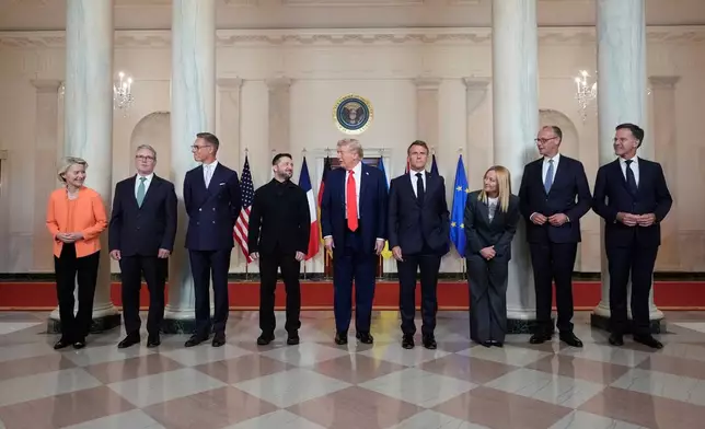 FILE - European Commission President Ursula von der Leyen, from left, British Prime Minister Keir Starmer, Finland's President Alexander Stubb, Ukrainian President Volodymyr Zelenskyy, President Donald Trump, France's President Emmanuel Macron, Italy's Prime Minister Giorgia Meloni, Germany's Chancellor Friedrich Merz and NATO Secretary General Mark Rutte stand before a group photo in the Grand Foyer of the White House, Monday, Aug. 18, 2025, in Washington. (AP Photo/Alex Brandon, File)