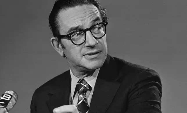FILE - Alan Greenspan chairman of the Council of Economic Advisers, chats with newsmen prior to his appearance on NBC's "Meet the Press", Sept. 29, 1974, in Washington. (AP Photo/Bob Daugherty, file)