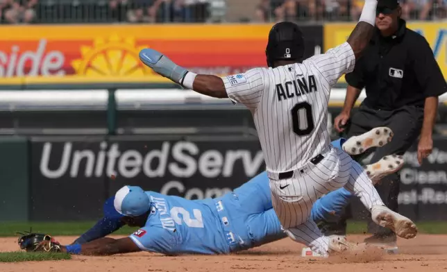 Chicago White Sox' Luisangel Acuña (0) is safe at second base as Kansas City Royals second baseman Tyler Tolbert (2) can't handle an errant throw during the seventh inning of a baseball game Saturday, June 27, 2026, in Chicago. (AP Photo/David Banks)