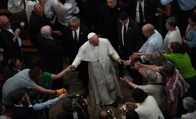Pope Leo XIV leaves at the end of a meeting with faithful and members of the diocesan charity and welfare organizations in the Church of Sant Agusti in Barcelona, Spain, Wednesday, June 10, 2026 (AP Photo/Alessandra Tarantino)