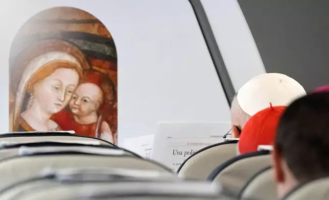 Pope Leo XIV reads L'Osservatore Romano newspaper aboard an ITA Airways Airbus A320neo during his flight from Rome to Madrid, Saturday, June 6, 2026, marking the start of a seven-day apostolic journey to mainland Spain and the Canary Islands. (AP Photo/Alessandra Tarantino, Pool)
