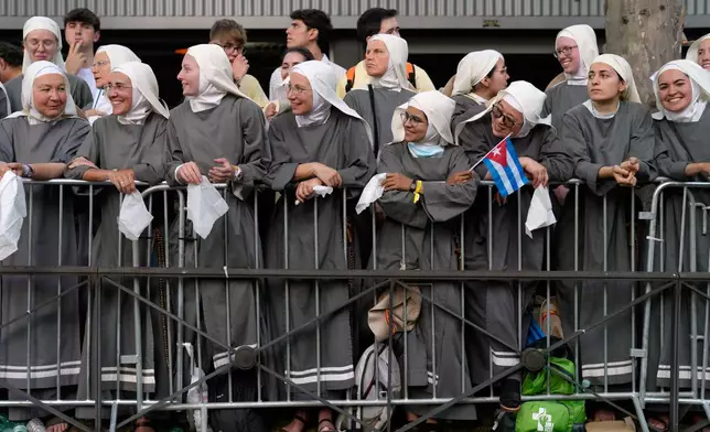 A group of nuns wait for the arrival of Pope Leo XIV during a prayer vigil with young people at Plaza de Lima in Madrid, Spain, Saturday, June 6, 2026, on the first day of his seven-day apostolic visit to mainland Spain and the Canary Islands. (AP Photo/Bernat Armangue)