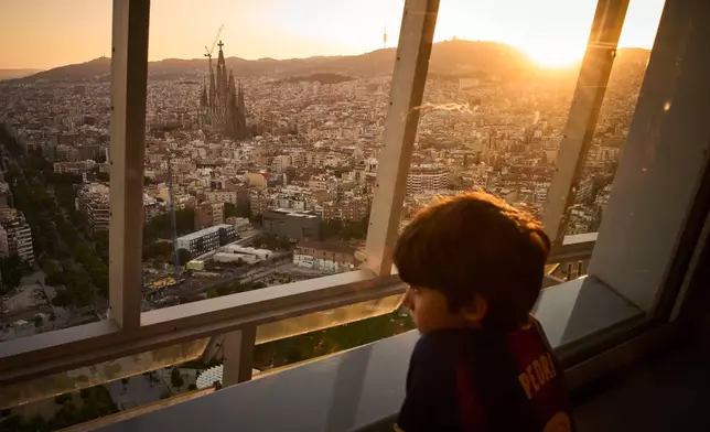 Antoni Gaudí's Basilica of the Sagrada Família stands at dusk as seen from the Mirador Torre Glòries in Barcelona, Spain, Tuesday, June 9, 2026. (AP Photo/Emilio Morenatti)