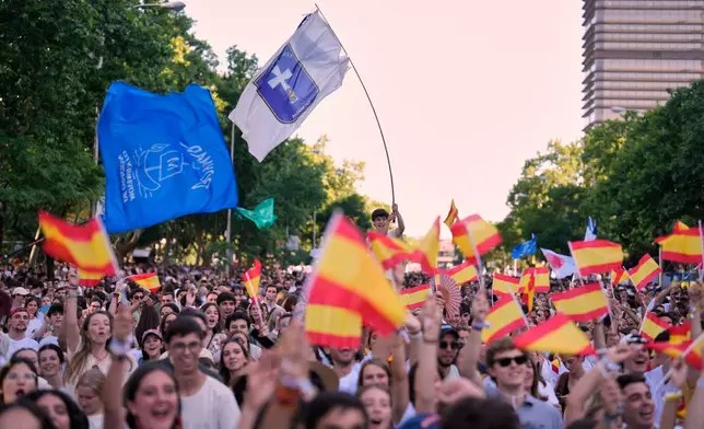 People wait for the arrival of Pope Leo XIV during a prayer vigil with young people at Plaza de Lima in Madrid, Spain, Saturday, June 6, 2026, on the first day of his seven-day apostolic visit to mainland Spain and the Canary Islands. (AP Photo/Bernat Armangue)