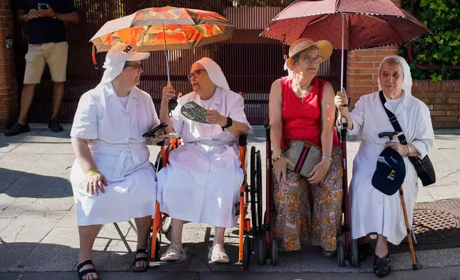 Nuns wait to greet Pope Leo XIV in Madrid, Monday, June 8, 2026. (AP Photo/Andrea Comas)
