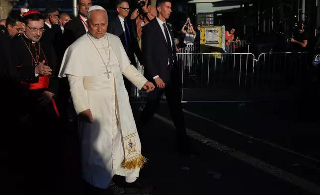 Pope Leo XIV, accompanied by the Archbishop of Madrid Cardinal José Cobo Cano, left,, arrives at Plaza de Lima in Madrid, Saturday, June 6, 2026, for a prayer vigil with young people on the first day of a seven-day apostolic journey to mainland Spain and the Canary Islands. (AP Photo/Alessandra Tarantino)