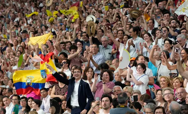 People react as Pope Leo XIV arrives on the occasion of a meeting with the diocesan community at the Santiago Bernabeu stadium in Madrid, Spain, Monday, June 8, 2026. (AP Photo/Bernat Armangue)