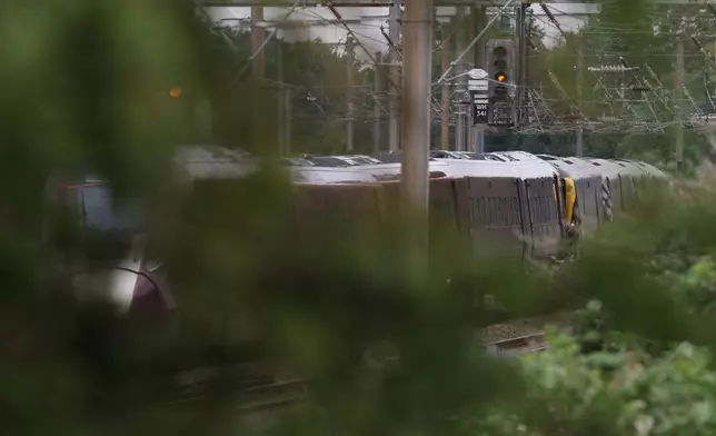 A train on the tracks outside Bedford, England, Saturday June 20, 2026, after two trains traveling south to London St. Pancras station collided outside the town of Bedford on Friday (Chris Radburn/PA via AP)