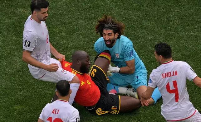 Belgium's Romelu Lukaku (9) hits Iran goalkeeper Alireza Beiranvand (1) during the World Cup Group G soccer match between Belgium and Iran in Inglewood, Calif., near Los Angeles, Sunday, June 21, 2026. (AP Photo/Jayne Kamin-Oncea)