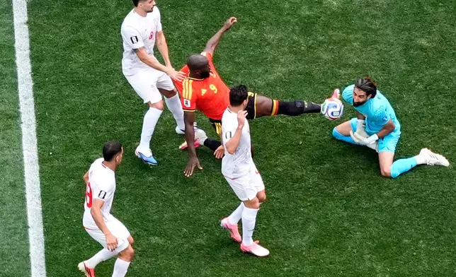 Belgium's Romelu Lukaku (9) challenges Iran goalkeeper Alireza Beiranvand (1) during the World Cup Group G soccer match between Belgium and Iran in Inglewood, Calif., near Los Angeles, Sunday, June 21, 2026. (AP Photo/Mark J. Terrill)