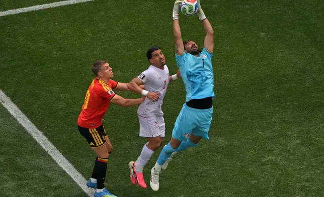 Iran goalkeeper Alireza Beiranvand (1) saves during the World Cup Group G soccer match between Belgium and Iran in Inglewood, Calif., near Los Angeles, Sunday, June 21, 2026. (AP Photo/Jayne Kamin-Oncea)