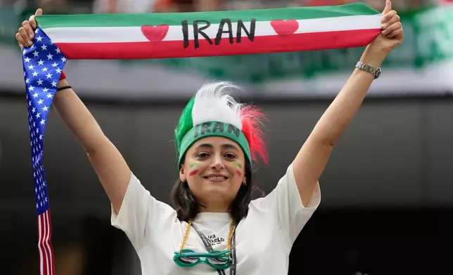 A fan of Iran holds up a scarf prior to the World Cup Group G soccer match between Belgium and Iran in Inglewood, Calif., near Los Angeles, Sunday, June 21, 2026. (AP Photo/Andre Penner)