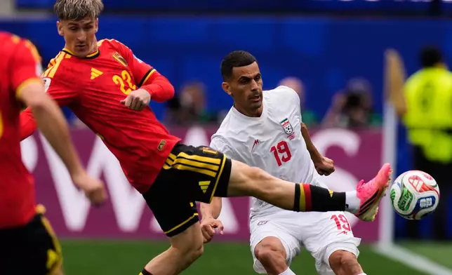 Iran's Ali Nemati (19) and Belgium's Nicolas Raskin battle for the ball during the World Cup Group G soccer match in Inglewood, Calif., near Los Angeles, Sunday, June 21, 2026. (AP Photo/Mark J. Terrill)