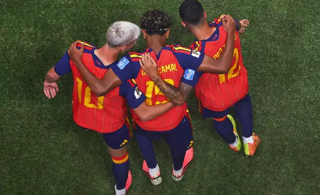Spain's Lamine Yamal (19) celebrates with teammates Dani Olmo (10) and Pedro Porro (12) after scoring during the World Cup Group H soccer match between Spain and Saudi Arabia in Atlanta, Sunday, June 21, 2026. (AP Photo/Colin Hubbard)