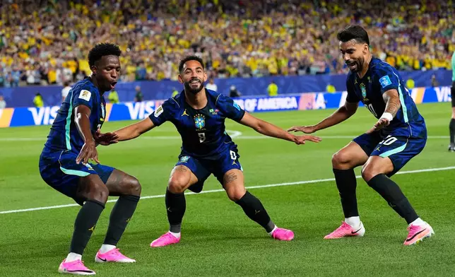 Brazil's Matheus Cunha (9) celebrates after scoring his side's second goal with Brazil's Vinicius Junior (7) and Lucas Paqueta (20) during the World Cup Group C soccer match between Brazil and Haiti in Philadelphia, Friday, June 19, 2026. (AP Photo/Petr David Josek)