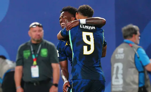 Brazil's Vinicius Junior (7) celebrates with his with teammate Matheus Cunha (9) after scoring his side's third goal during the World Cup Group C soccer match between Brazil and Haiti in Philadelphia, Friday, June 19, 2026. (AP Photo/Derik Hamilton)