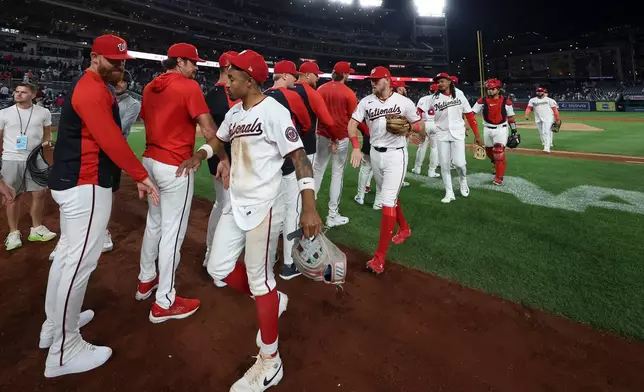 Washington Nationals players greet each other after defeating the Kansas City Royals in a baseball game, Monday, June 15, 2026, in Washington. (AP Photo/Terrance Williams)