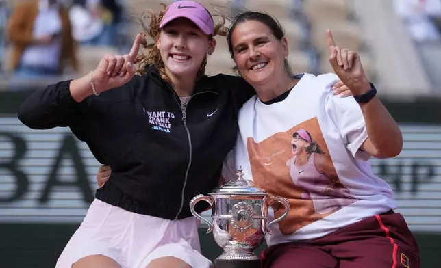 Russia's Mirra Andreeva poses with her coach Conchita Martinez after winning the final tennis match at the French Open in Paris, Saturday, June 6, 2026. (AP Photo/Thibault Camus)