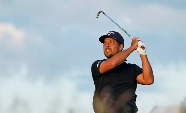 Xander Schauffele watches his tee shot on the 17th hole during the third round of the U.S. Open golf tournament at Shinnecock Hills Golf Club in Southampton, N.Y., Saturday, June 20, 2026.(AP Photo/David J. Phillip)