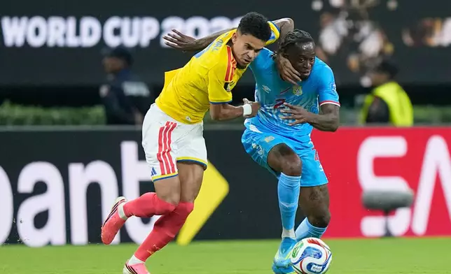 Colombia's Luis Diaz, left, challenges for the ball with Congo's Aaron Wan-Bissaka (2) during the World Cup Group K soccer match between Colombia and Congo in Zapopan, near Guadalajara, Mexico, Tuesday, June 23, 2026. (AP Photo/Fernando Llano)