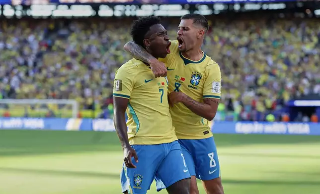 Brazil's Vinicius Junior (7) celebrates with teammate Bruno Guimaraes (8) after scoring during the World Cup Group C soccer match against Morocco in East Rutherford, N.J., near New York, Saturday, June 13, 2026. (AP Photo/Adam Hunger)