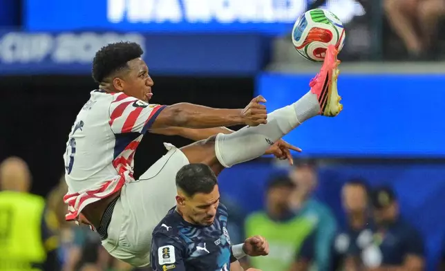 United States' Alex Freeman, top, reaches for the ball over Paraguay's Antonio Sanabria during the World Cup Group D soccer match in Inglewood, Calif., near Los Angeles, Friday, June 12, 2026. (AP Photo/Jayne Kamin-Oncea)