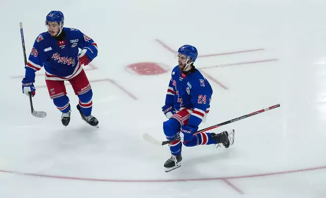 Kitchener Rangers' Jack Pridham (24) and Christian Humphreys (48) celebrate Pridham's goal during the third period of the Memorial Cup final hockey game against the Everett Silvertips in Kelowna, British Columbia, Sunday, May 31, 2026. (Darryl Dyck/The Canadian Press via AP)