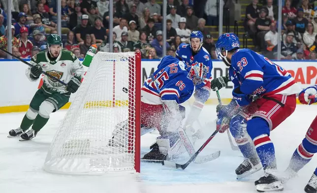 Kitchener Rangers goalie Christian Kirsch (65) allows a goal to Everett Silvertips' Matias Vanhanen, back right, during the first period of the Memorial Cup final hockey game in Kelowna, British Columbia, Sunday, May 31, 2026. (Darryl Dyck/The Canadian Press via AP)