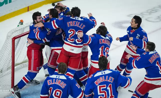Kitchener Rangers players celebrate after defeating the Everett Silvertips to win the Memorial Cup final hockey game in Kelowna, British Columbia, on Sunday, May 31, 2026. (Darryl Dyck/The Canadian Press via AP)