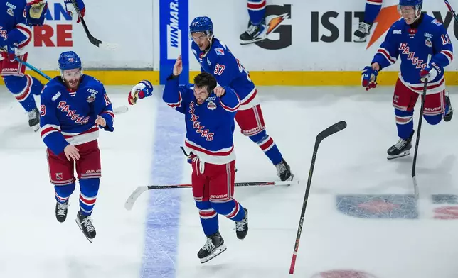 Kitchener Rangers' Dylan Edwards, front center, Luke Ellinas, left, Tanner Lam, back center, and Cameron Arquette, right, celebrate after Kitchener defeated the Everett Silvertips to win the Memorial Cup final hockey game in Kelowna, British Columbia, on Sunday, May 31, 2026. (Darryl Dyck/The Canadian Press via AP)