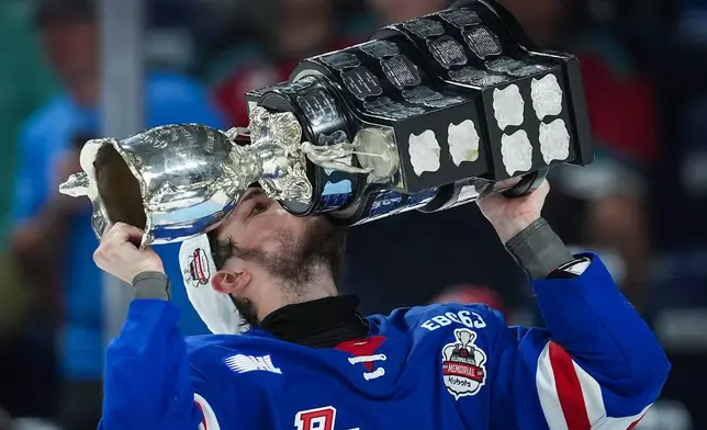Kitchener Rangers' Christian Humphreys kisses the Memorial Cup after Kitchener defeated the Everett Silvertips to win the Memorial Cup final hockey game in Kelowna, British Columbia, on Sunday, May 31, 2026. (Darryl Dyck/The Canadian Press via AP)