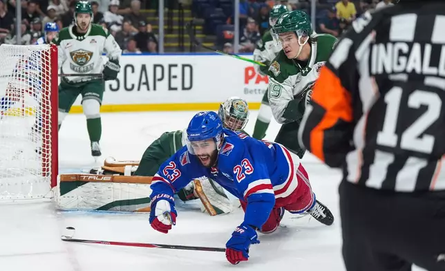 Kitchener Rangers' Sam O'Reilly (23) falls in front of Everett Silvertips' Zackary Shantz (19) during the second period of the Memorial Cup final hockey game in Kelowna, British Columbia, Sunday, May 31, 2026. (Darryl Dyck/The Canadian Press via AP)