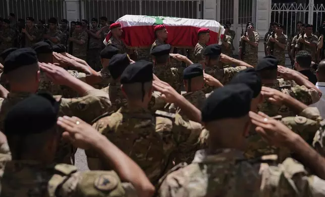 Lebanese army soldiers carry the coffin of Brig. Gen. Wissam Sabra, who was killed Saturday in south Lebanon along with a captain and a soldier in an Israeli airstrike, during his funeral procession in Beirut, Lebanon, Sunday, June 7, 2026. (AP Photo/Hassan Ammar)