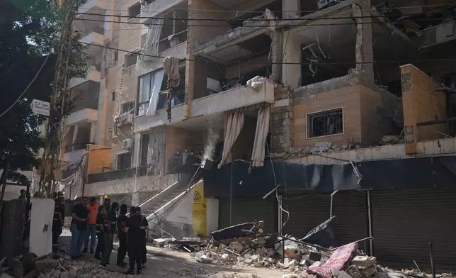 Lebanese security officers gather at the site where an Israeli airstrike hit a building in Dahiyeh, Beirut's southern suburb, Lebanon, Sunday, June 7, 2026. (AP Photo/Hassan Ammar)