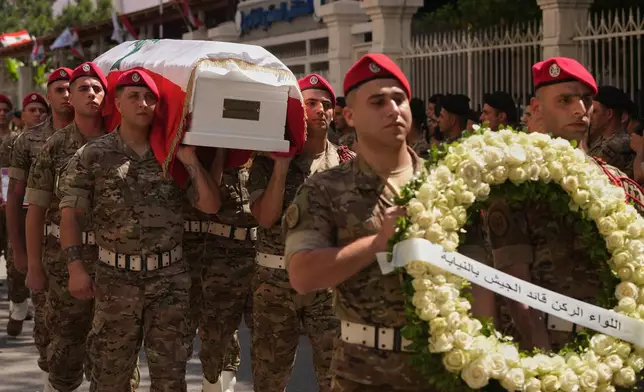 Army soldiers carry the coffin of Brig. Gen. Wissam Sabra, who was killed Saturday in south Lebanon along with a captain and a soldier in an Israeli airstrike, during his funeral procession in Beirut, Sunday, June 7, 2026. (AP Photo/Hassan Ammar)